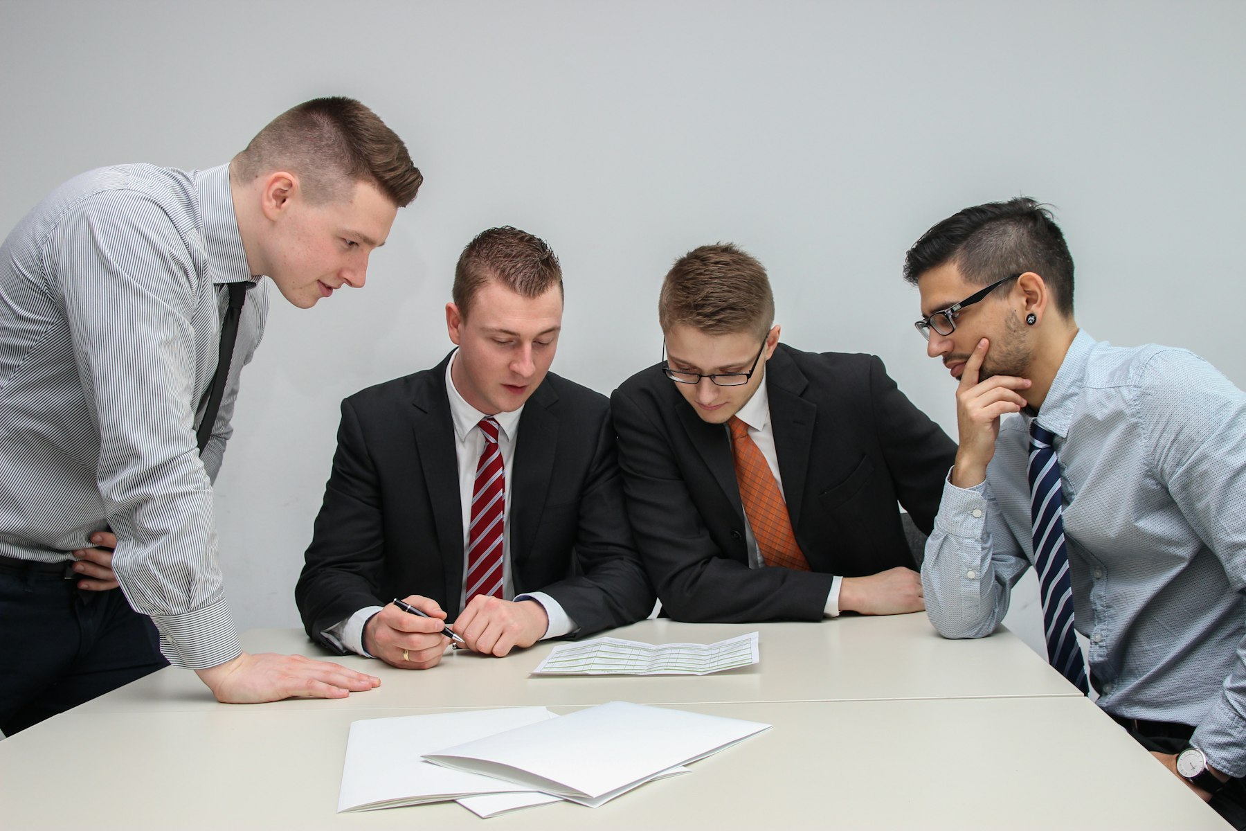 Technical consulting: advisers reviewing documents at a meeting table
